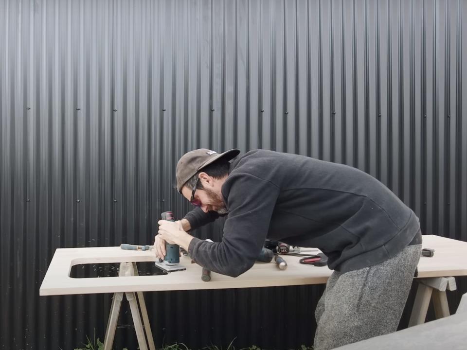 The couple worked on a makeshift bench that they set up next to the cabin.