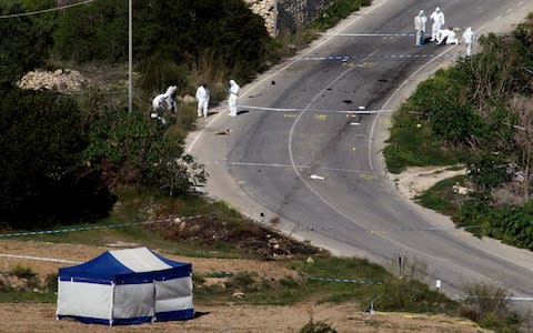 The bomb was so powerful that it blew the journalist's car off the road and into a field - Credit: Reuters