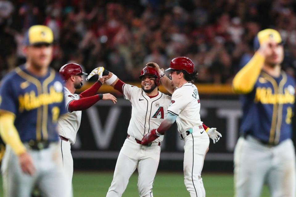 Third baseman Eugenio Suarez (28) of the Arizona Diamondbacks is harassed by first baseman Christian Walker (53) of the Arizona Diamondbacks and outfielder Corbin Carroll (7) of the Arizona Diamondbacks after his walk-off hit on September 15, 2024 at Chase Field in Phoenix.