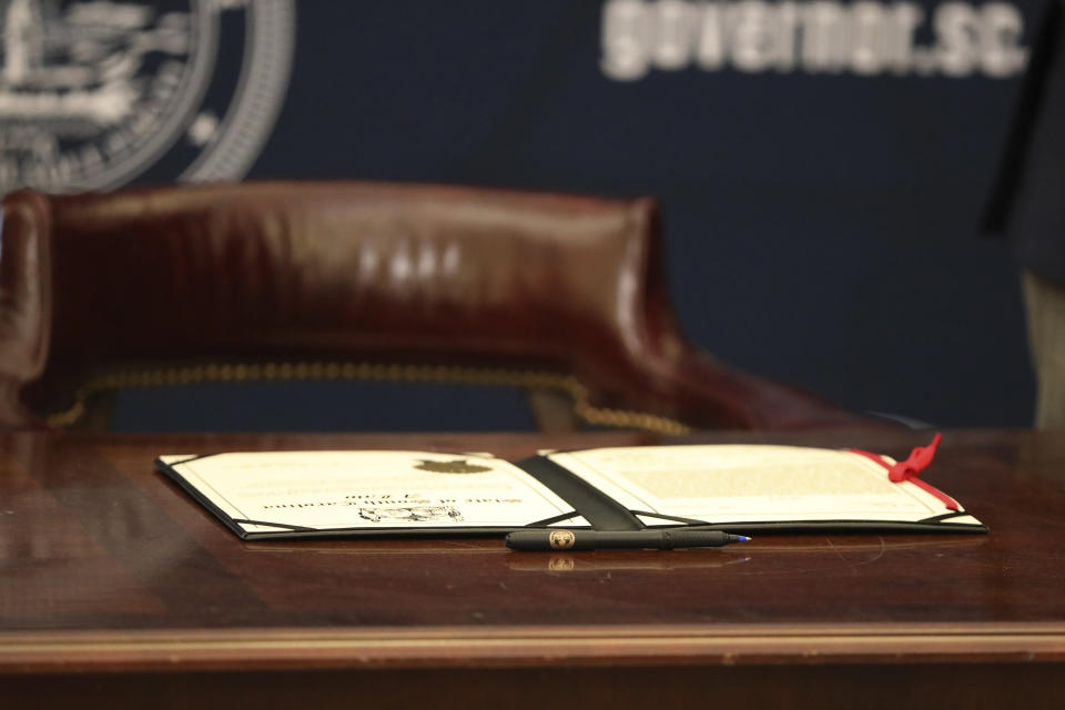 A ceremonial copy of a bill allowing anyone who can legally own a gun to openly carry the weapon in the state sits on a desk at an event on Tuesday, March 19, 2024, in Columbia, S.C. Gov. Henry McMaster signed the bill into law March 7. (AP Photo/Jeffrey Collins)