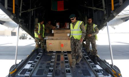 Afghan National Army (ANA) soldiers load military equipment onto a C-130 military transport plane before a flight in Kabul, Afghanistan July 9, 2017. REUTERS/Omar Sobhani