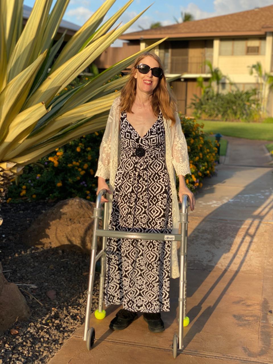 Antonia Hall, seen here wearing a long dress and dark sunglasses near her home in Maui, Hawaii, with the walker she used to get around.