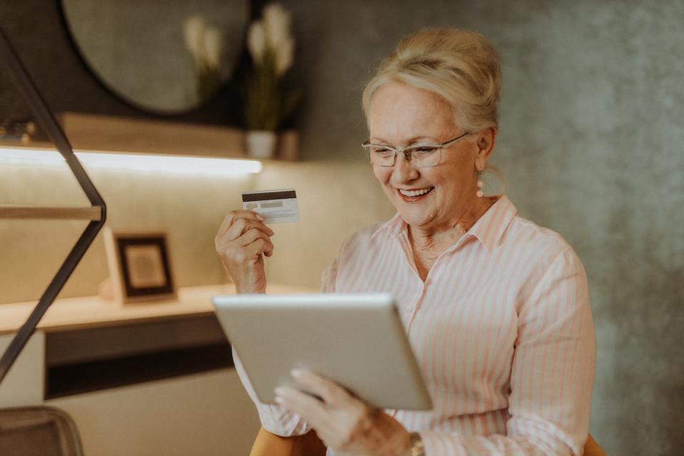 A good credit score is reason to celebrate because it means you have access to cheaper borrowing. <a href="https://www.gettyimages.com/detail/photo/senior-woman-at-home-royalty-free-image/1361629869?phrase=good+credit+score+&adppopup=true" rel="nofollow noopener" target="_blank" data-ylk="slk:milan 2099/E+ via Getty Images;elm:context_link;itc:0;sec:content-canvas" class="link ">milan 2099/E+ via Getty Images</a>