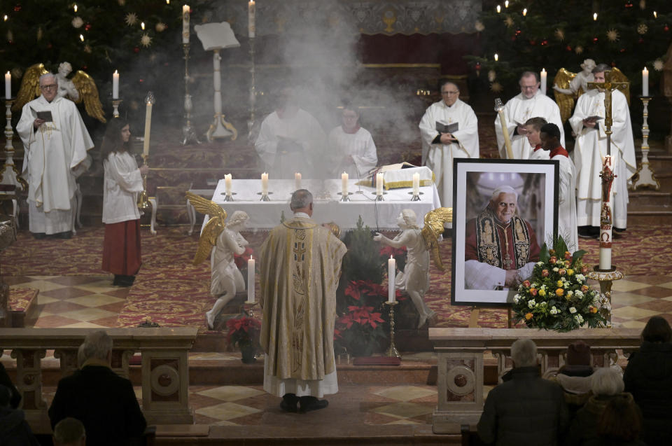 Believers and clergy attend a mass for Pope Emeritus Benedict XVI at the Saint Magdalena church in Altoetting, Germany, Saturday, Dec. 31, 2022. Pope Emeritus Benedict XVI, the German theologian who will be remembered as the first pope in 600 years to resign, has died, the Vatican announced Saturday. He was 95. (AP Photo/Andreas Schaad)