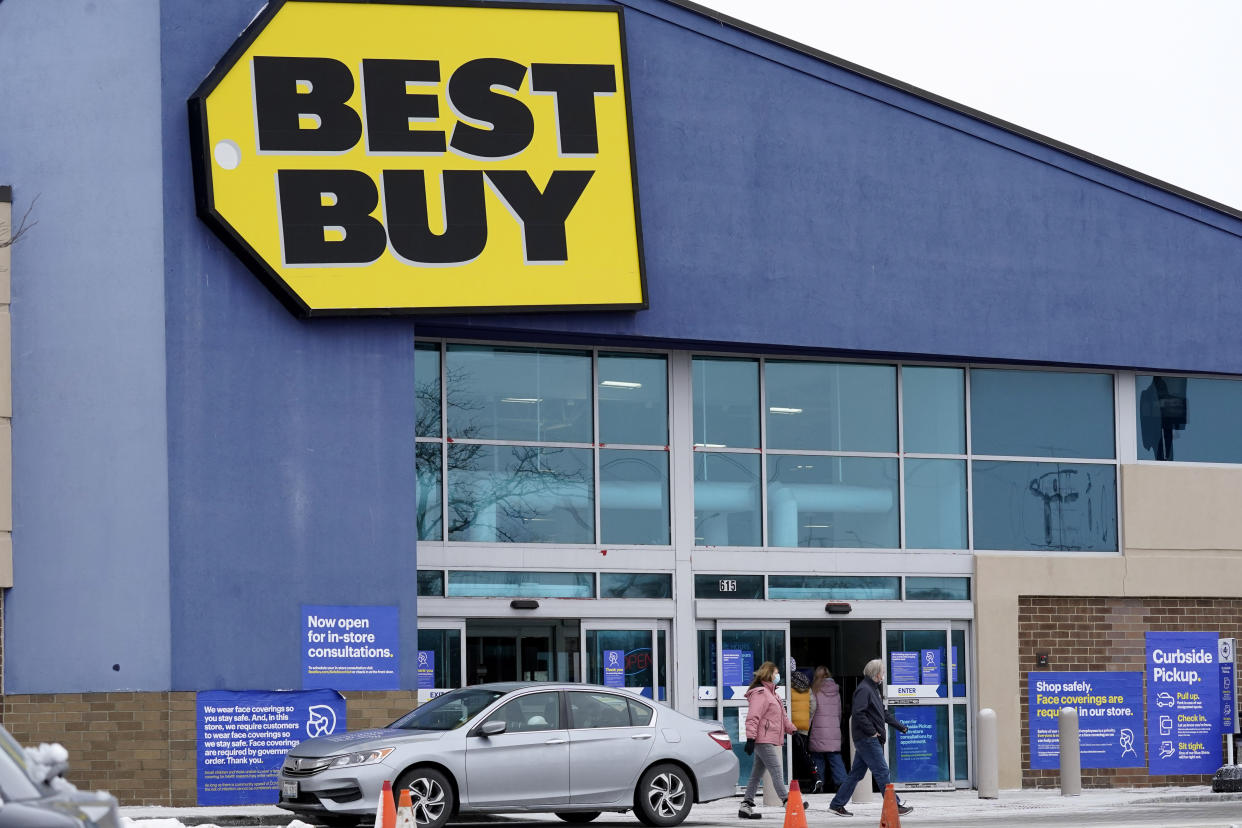 Shoppers enter and exit Best Buy store in Arlington Heights, Ill., Saturday, Feb. 6, 2021. Best Buy is closing five stores in four states in the next month. The retailer plans to close two Richmond, Va., area stores, along with one store each in Syracuse, N.Y., Carbondale, Ill., and Brockton, Mass. (AP Photo/Nam Y. Huh)