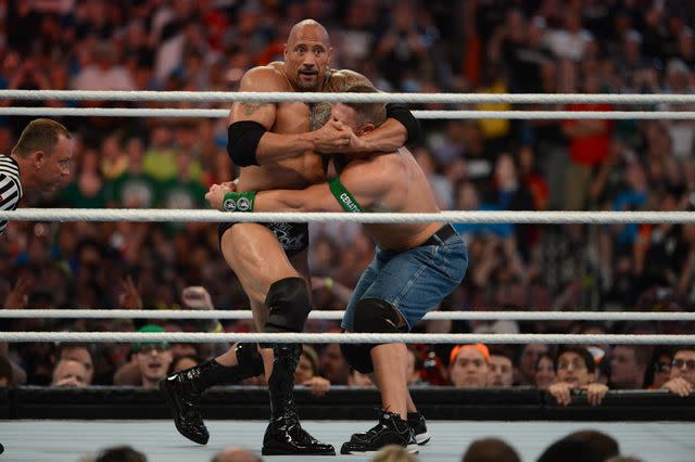 <p>Ron Elkman/Sports Imagery/Getty </p> Dwayne Johnson and John Cena