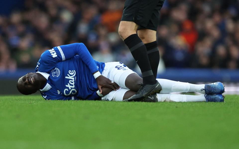 Everton's Amadou Onana reacts after sustaining an injury