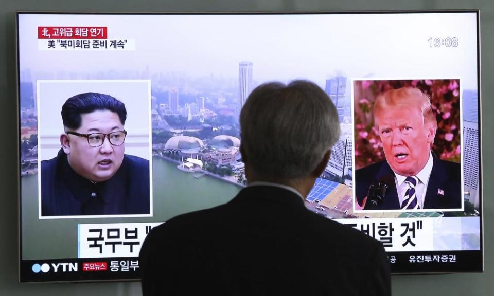 A man watches a TV screen showing file footage of US president Donald Trump, right, and North Korean leader Kim Jong Un at the Seoul railway station in South Korea on Wednesday.