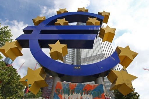 A giant Euro symbol outside the European Central Bank in Frankfurt. Construction cranes on the site of the new Raiffeisen building to be completed in Vienna