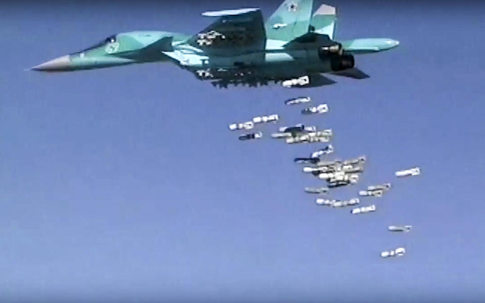 FILE - In this file image made from video provided by Russian Defense Ministry press service on Aug. 18, 2016, shows a Russian combat fighter bomber Su-34 unloads its bombs over a target in Syria. A Syrian-led human rights group said Wednesday, Oct. 31, 2018 that it has documented more than 1,400 incidents in which Russian forces indiscriminately targeted civilians and civilian infrastructure in the three years since Moscow intervened in the civil war in Syria. (Russian Defense Ministry Press Service photo via AP, File)