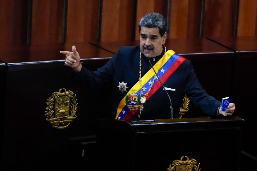 FILE – Venezuelan President Nicolas Maduro holds a small copy of his nation’s constitution during ceremony marking the start of the judicial year at the Supreme Court in Caracas, Venezuela, Jan. 31, 2024. A secret memo obtained by The Associated Press details a covert operation by the U.S. Drug Enforcement Administration that sent undercover operatives into Venezuela to record and build drug-trafficking cases against the country’s leadership including Venezuelan President Nicolás Maduro. (AP Photo/Ariana Cubillos, File)