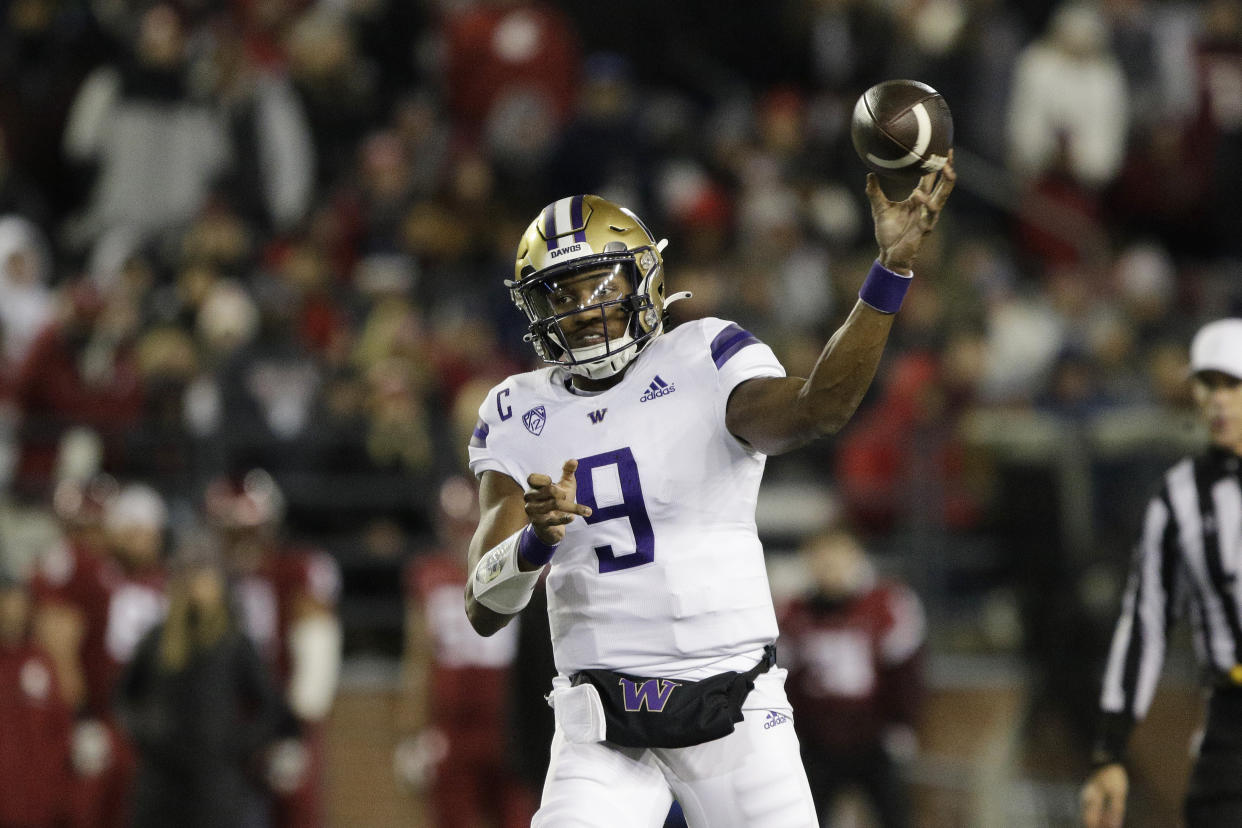 Washington quarterback Michael Penix Jr. throws a pass during the first half of an NCAA college football game against Washington State, Saturday, Nov. 26, 2022, in Pullman, Wash. (AP Photo/Young Kwak)