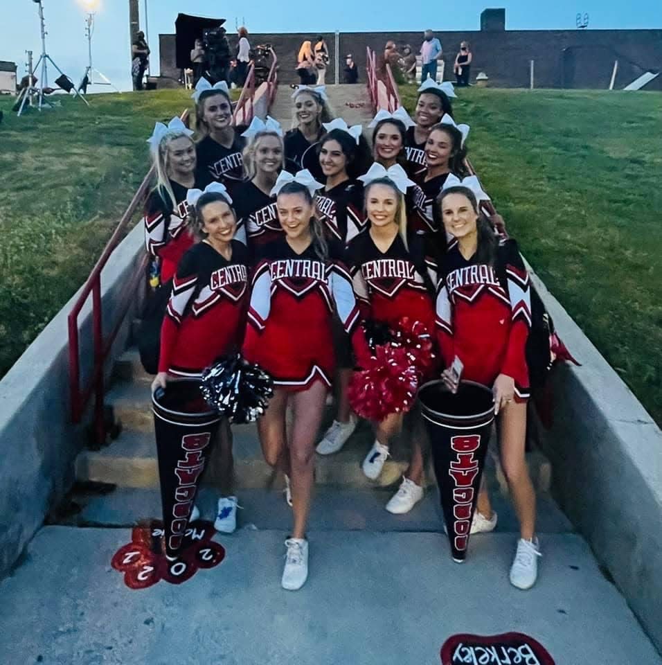 Central High School cheerleaders pose for a photo after shooting a scene with Kelsea Ballerini on the stairs that feature their Bobcat paw print and numbers outside the stadium.