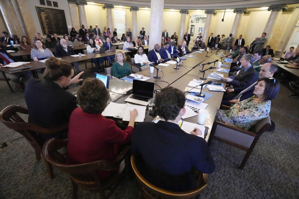 Members of the Mississippi House of Representatives Medicaid Committee listen as representatives from the Hilltop Institute, a nonpartisan research organization, left, present a brief on the economic impact of Medicaid expansion in Mississippi, to the legislators, media and lobbyists at the state Capitol in Jackson, Miss., Tuesday, Feb. 20, 2024. (AP Photo/Rogelio V. Solis)