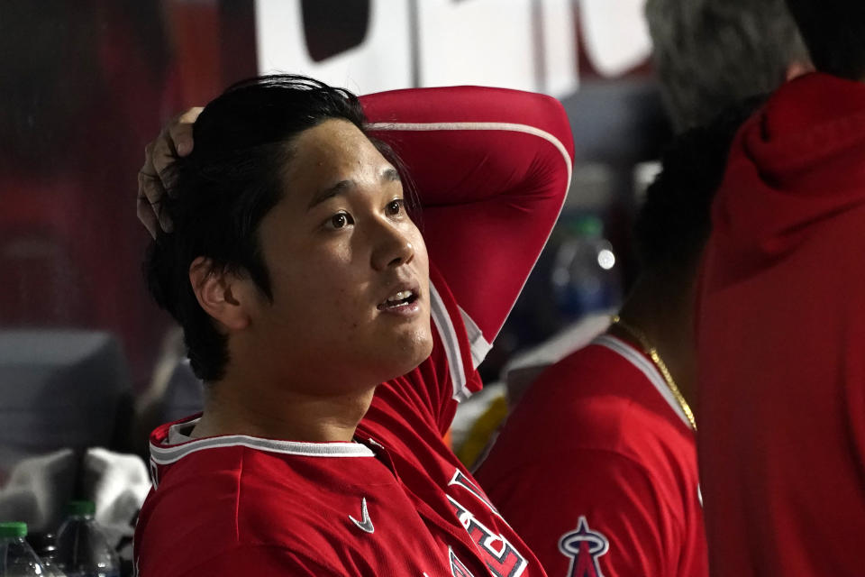 Los Angeles Angels' Shohei Ohtani sits in the dugout after being called out on strikes during the fourth inning of the team's baseball game against the Chicago White Sox on Tuesday, Sept. 14, 2021, in Chicago. (AP Photo/Charles Rex Arbogast)