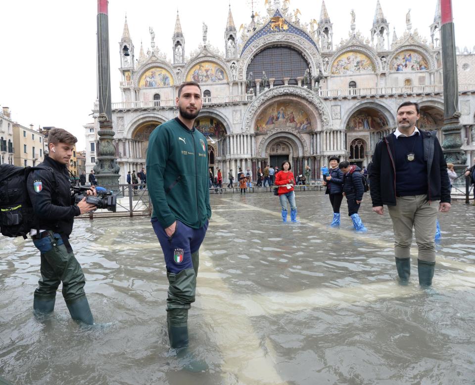 Italy's goalkeeper Gianluigi Donnarumma is seen in St. Mark's Square during a solidarity visit to Venice following the exceptional high water that brought the city to its knees, in Venice, northern Italy, Saturday, Nov. 16, 2019. Four days ago, the Italian lagoon city experienced its worst flooding in more than 50 years. (Andrea Merola/ANSA via AP)