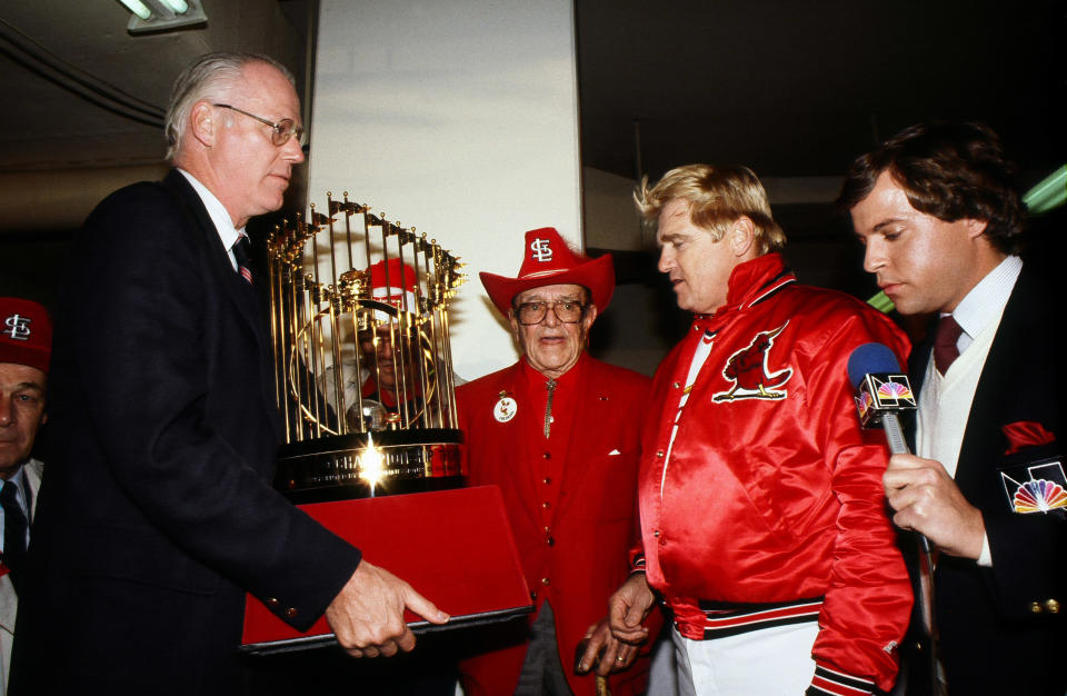 MLB Commissioner Bowie Kuhn presents the World Series trophy to Gussie Busch and Whitey Herzog of the St. Louis Cardinals. (Photo by Rich Pilling/Getty Images)