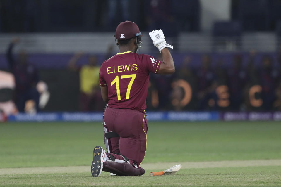 West Indies' Evin Lewis takes a knee as the start of the Cricket T20 World Cup match between England and the West Indies at the Dubai International Cricket Stadium, in Dubai, UAE, Saturday, Oct. 23, 2021. (AP Photo/Aijaz Rahi)