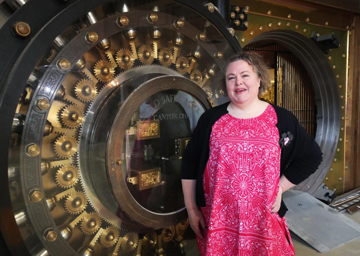 Shannon Okey, founder of Cleveland Bazaar, poses at the vault door of the former Second National Bank in The 159 Main building in downtown Akron on March 1. The space will be the new home of Akron Bazaar.