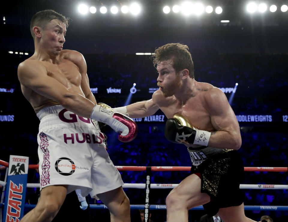 Gennady Golovkin, left, and Canelo Alvarez trade punches in the second round during a middleweight title boxing match, Saturday, Sept. 15, 2018, in Las Vegas. (AP Photo/Isaac Brekken)