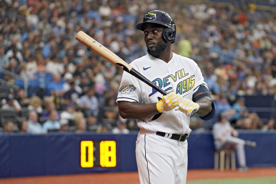 Tampa Bay Rays' Randy Arozarena waits on deck near the new MLB pitch clock during the sixth inning of a baseball game against the Detroit Tigers Thursday, March 30, 2023, in St. Petersburg, Fla. (AP Photo/Chris O'Meara)