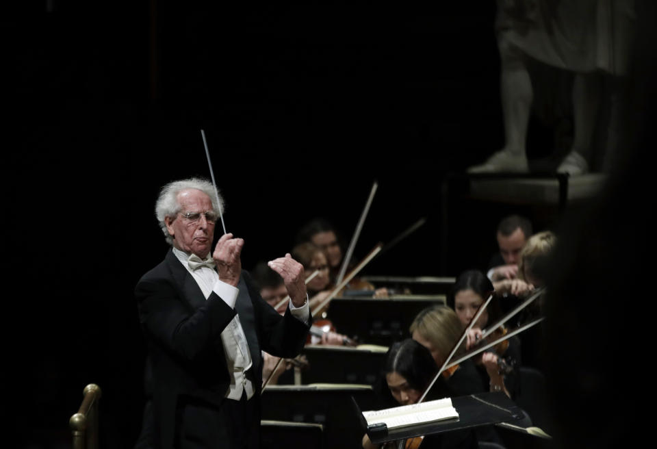 In this Feb. 14, 2019 photo, Benjamin Zander conducts the Boston Philharmonic Orchestra at the Sanders Theatre in Cambridge, Mass. The internationally acclaimed conductor, who approaches his 80th birthday on March 9, has spent half his life leading the Boston Philharmonic Orchestra, which he founded in 1979. (AP Photo/Elise Amendola)