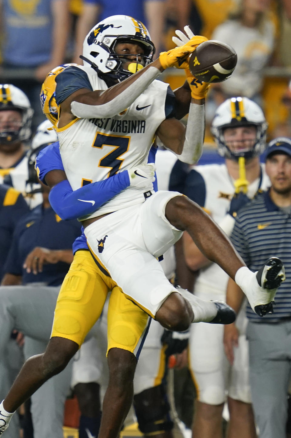 West Virginia wide receiver Kaden Prather (3) catches a pass for a first down against Pittsburgh defensive back M.J. Devonshire (12) during the first half of an NCAA college football game Thursday, Sept. 1, 2022, in Pittsburgh. (AP Photo/Keith Srakocic)