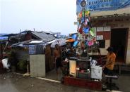 Victims of super Typhoon Haiyan decorate their improvised Christmas tree with different appliances, plastic plates and toys which they salvaged at the ravaged town of Anibong, Tacloban city, central Philippines December 24, 2013, a month after Typhoon Haiyan battered central Philippines. REUTERS/Romeo Ranoco