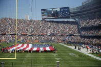 <p>Fans watch the unfurled U.S flag on the field during the playing of the national anthem before an NFL football game between the Chicago Bears and Pittsburgh Steelers, Sunday, Sept. 24, 2017, in Chicago. The Pittsburgh Steelers players did not come out to the field during the anthem. (AP Photo/Charles Rex Arbogast) </p>