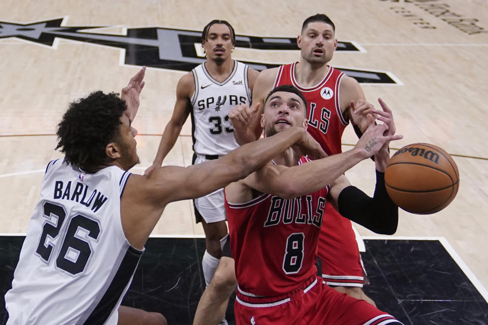 Chicago Bulls guard Zach LaVine (8) is fouled by San Antonio Spurs forward Dominick Barlow (26) as he drives to the basket during the second half of an NBA basketball game in San Antonio, Saturday, Jan. 13, 2024. (AP Photo/Eric Gay)