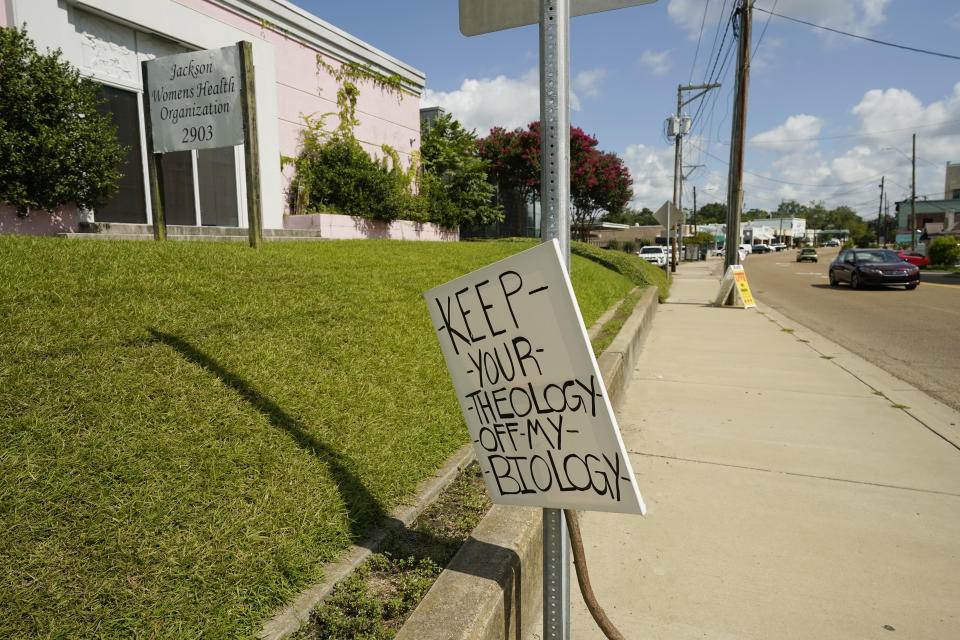 A lone abortion rights protest sign rests on the sidewalk by the Jackson Women's Health Organization clinic in Jackson, Miss., Friday, July 8, 2022. The clinic was the only facility that performed abortions in the state. (AP Photo/Rogelio V. Solis)