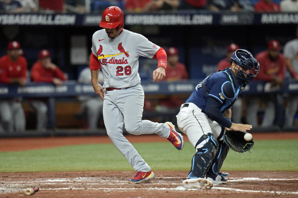 St. Louis Cardinals' Nolan Arenado (28) scores around Tampa Bay Rays catcher Rene Pinto on an RBI single by Jordan Walker during the third inning of a baseball game Wednesday, Aug. 9, 2023, in St. Petersburg, Fla. (AP Photo/Chris O'Meara)