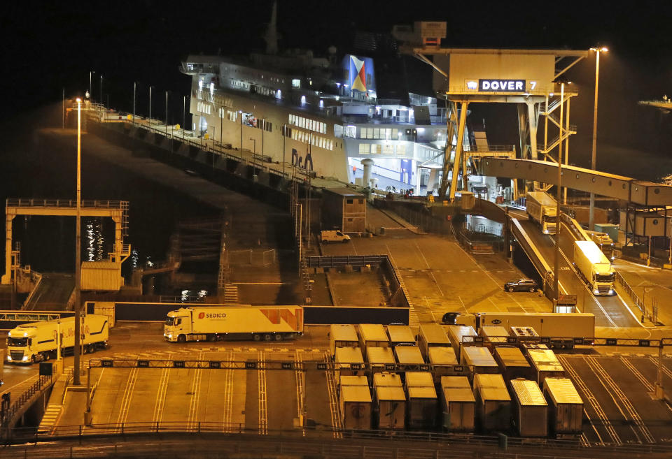 Lorries disembark the first ferry that arrived after the end of the transition period with the EU at the port in Dover, Friday, Jan. 1, 2021. Britain left the European bloc's vast single market for people, goods and services at 11 p.m. London time, midnight in Brussels, completing the biggest single economic change the country has experienced since World War II.(AP Photo/Frank Augstein)