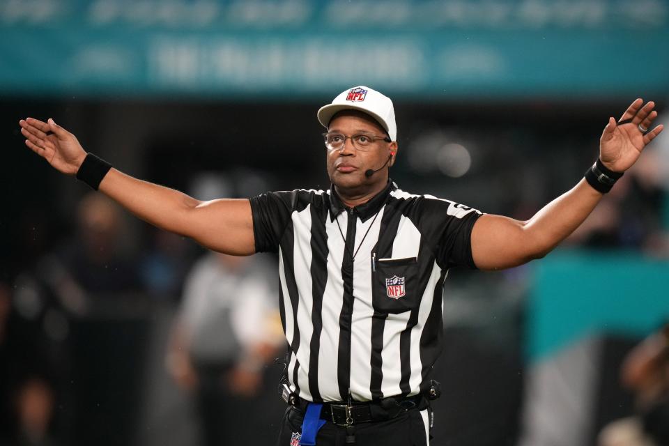 NFL referee Ron Torbert (62) signals during the second half between the Miami Dolphins and the Baltimore Ravens at Hard Rock Stadium.