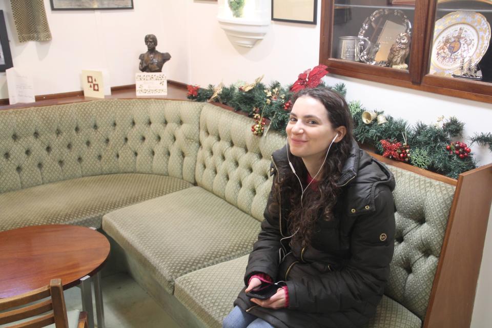 Insider reporter Talia Lakritz sits on a couch on the Royal Yacht Britannia.