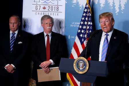 U.S. President Donald Trump gives a press briefing with U.S. National Security Advisor John Bolton and Larry Kudlow at the G7 summit in the Charlevoix city of La Malbaie, Quebec, Canada June 9, 2018. REUTERS/Leah Millis