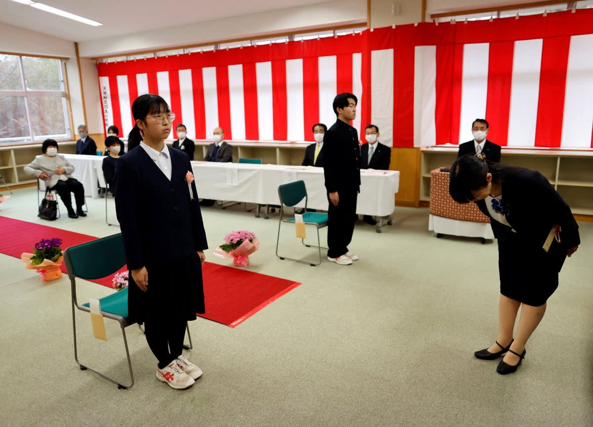 Eita Sato, 15, and Aoi Hoshi, 15, the only two students at Yumoto Junior High School, attend their graduation ceremony, in Ten-ei Village, Fukushima prefecture (Reuters)