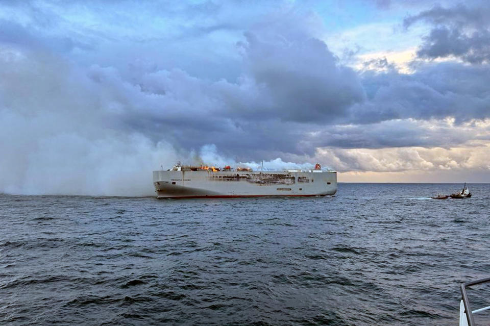 Smoke and flames are seen on a freight ship in the North Sea, about 27 kilometers (17 miles) north of the Dutch island of Ameland, Wednesday, July 26, 2023. A fire on the freight ship Fremantle Highway, carrying nearly 3,000 cars, was burning out of control Wednesday in the North Sea, and the Dutch coast guard said it was working to save the vessel from sinking close to an important habitat for migratory birds. (Kustwacht Nederland/Coastguard Netherlands via AP)
