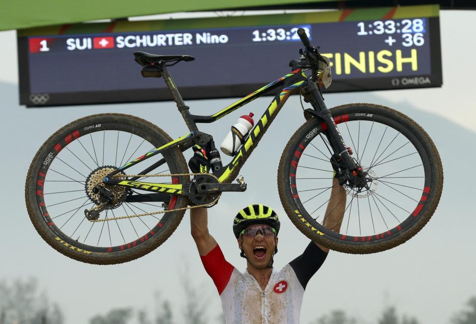 <p>Nino Schurter (SUI) of Switzerland celebrates winning the gold medal. (Reuters) </p>