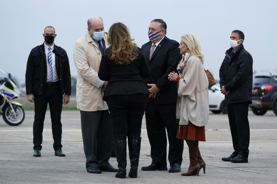 U.S. Secretary of State Mike Pompeo, third from right, and his wife Susan, third from left, speak with Jacques Jouslin de Noray of France's Ministry of Foreign Affairs, second from left, and U.S. Ambassador to France Jamie McCourt, second from right, after stepping off a plane at Paris Le Bourget Airport, Saturday, Nov. 14, 2020, in Le Bourget, France. Pompeo is beginning a 10-day trip to Europe and the Middle East. (AP Photo/Patrick Semansky, Pool)