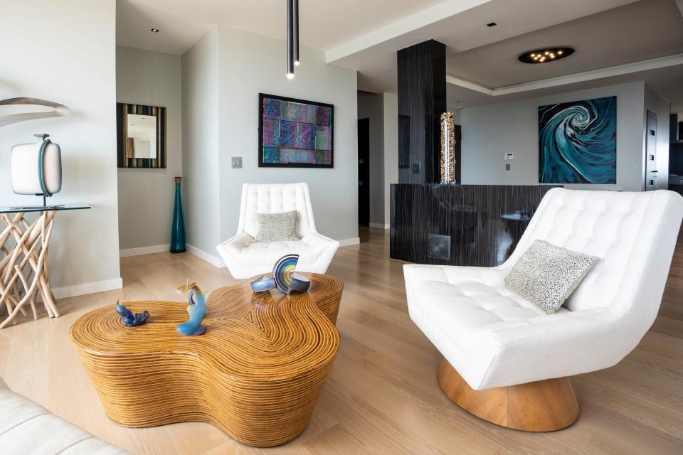 Furniture with curved and rounded edges in a renovated Fort Lee apartment.