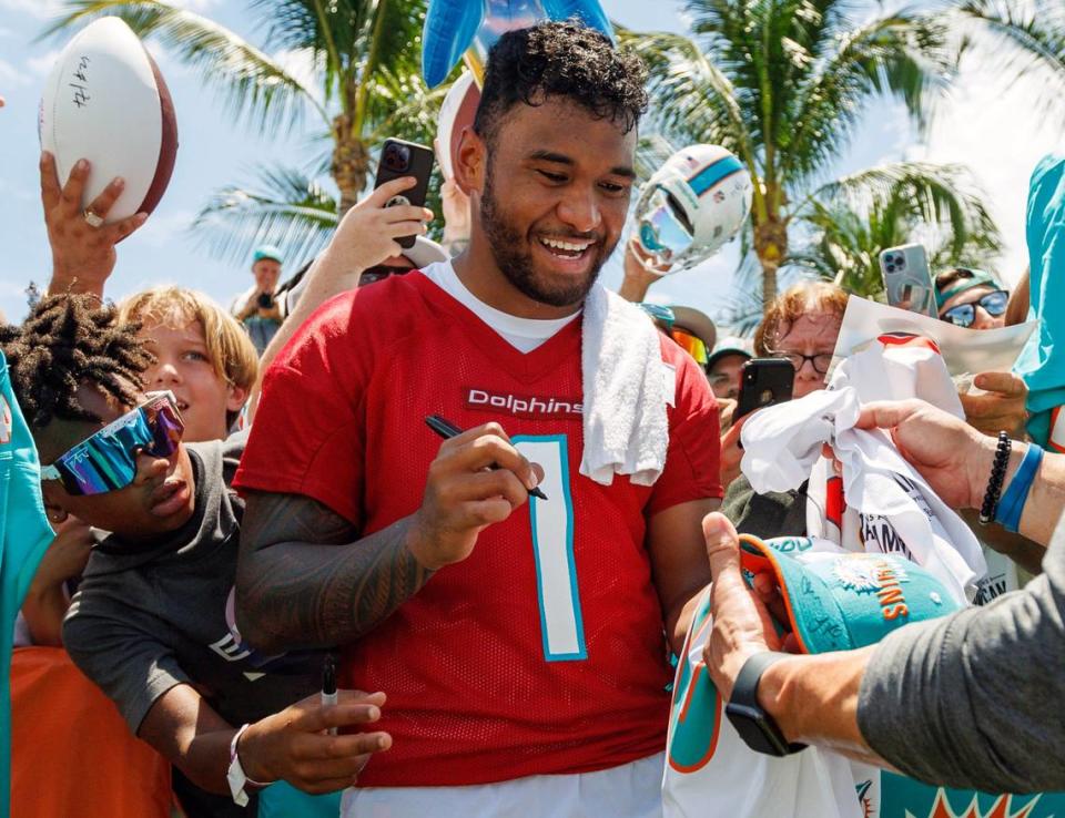 Miami Dolphins quarterback Tua Tagovailoa (1) sign autographs for fans after NFL football training camp at Baptist Health Training Complex in Hard Rock Stadium on Sunday, July 30, 2023 in Miami Gardens, Florida.