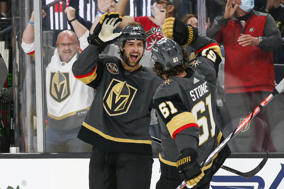 Vegas Golden Knights defenseman Nicolas Hague, left, celebrates his goal against the Seattle Kraken with right wing Mark Stone (61) during the second period of an NHL hockey game Tuesday, Oct. 12, 2021, in Las Vegas. (AP Photo/Chase Stevens)