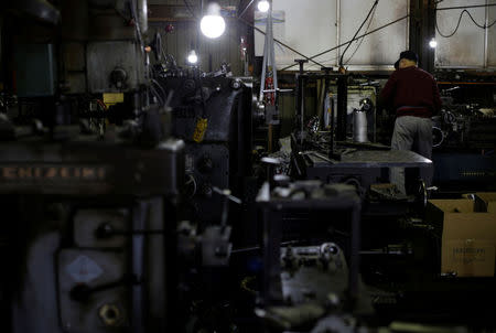 A man works at a factory that manufactures iron pipe fittings in the Keihin industrial zone in Kawasaki, south of Tokyo, Japan, April 16, 2013. REUTERS/Toru Hanai/File Photo