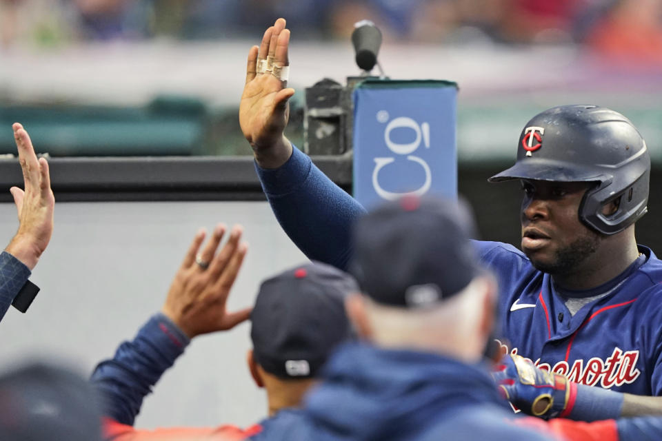 Minnesota Twins' Miguel Sano celebrates with teammates after Sano hit a solo home run during the seventh inning of the team's baseball game against the Cleveland Indians, Wednesday, Sept. 8, 2021, in Cleveland. (AP Photo/Tony Dejak)