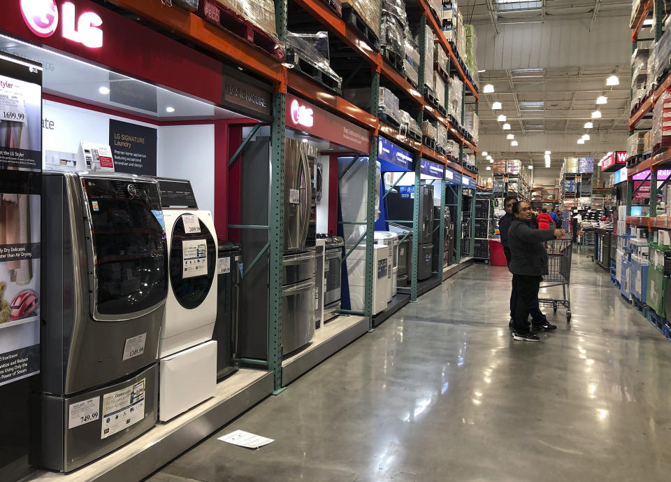 In this May 13, 2019, photo a woman and a man shop for appliances at a retail store in New Rochelle, N.Y. On Wednesday, June 26, the Commerce Department releases its May report on durable goods. (AP Photo/Julie Jacobson)