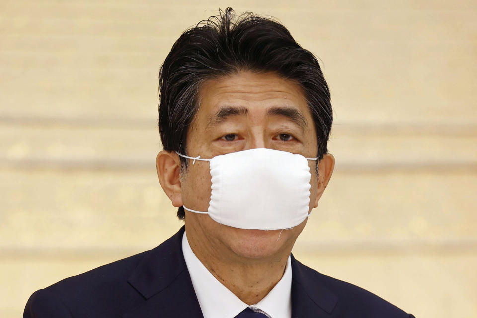 Japan's Prime Minister Shinzo Abe speaks during a meeting of government and ruling party officials at his office in Tokyo Wednesday, May 27, 2020. Japan’s Cabinet has approved a proposed 32 trillion-yen ($296 billion) supplementary budget to help fund measures to cushion the blow to the economy from the coronavirus pandemic. (Kyodo News via AP)