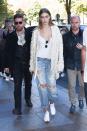 <p>In a pearl braided jacket by Jonathan Simkhai, white low-cut tee, round sunglasses, pearl-embellished ripped boyfriend jeans and white Reebok trainers while leaving the Miu Miu show in Paris.</p>