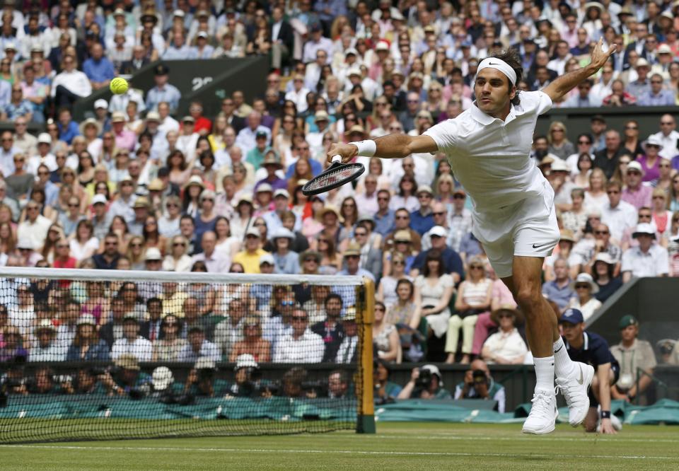 Roger Federer of Switzerland hits a return during his men's singles final tennis match against Novak Djokovic of Serbia at the Wimbledon Tennis Championships, in London July 6, 2014. REUTERS/Sang Tan