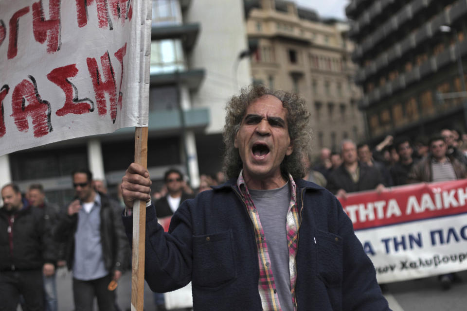 Shipyard workers chant slogans outside the Greek Ministry of Finance during a protest to demand their unpaid wages in central Athens, on Thursday, March 15, 2012. Countries in the 17-nation eurozone on Wednesday formally approved a second bailout for Greece and authorized the release of euro39.4 billion ($51.44 billion), as they had signaled last week. (AP Photo/Petros Giannakouris)